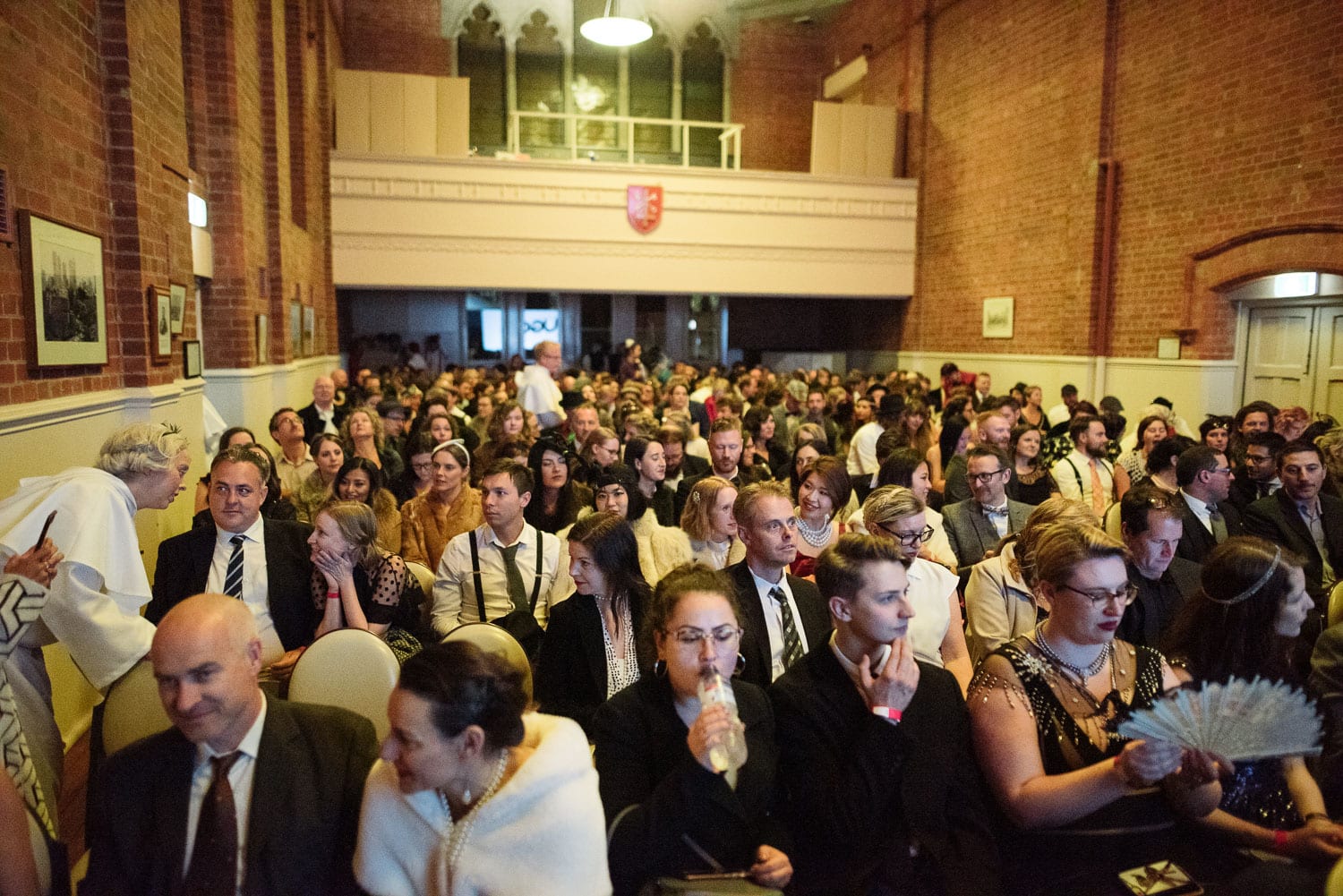 Costumed guests sit in a church