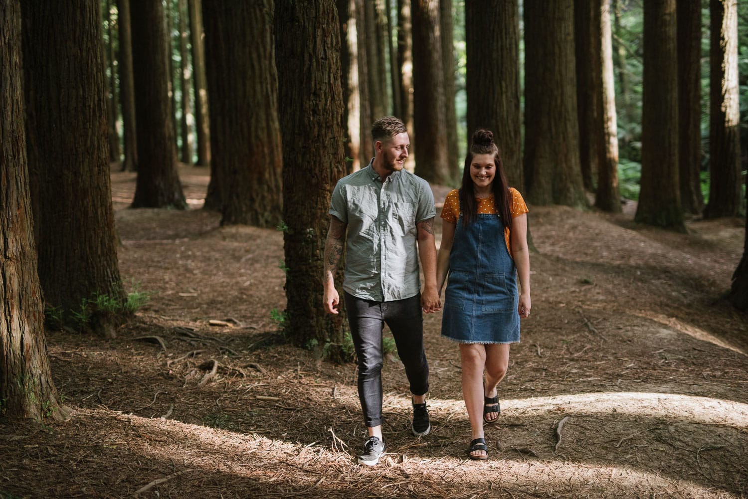 Chelsea and Luke walk through the redwood forest