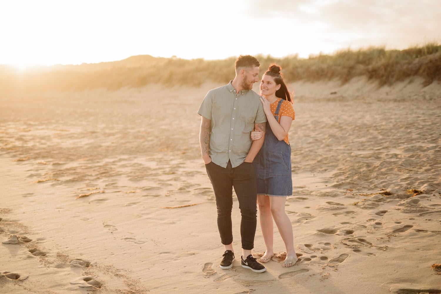 Couple in golden sunset light at Apollo Bay beach