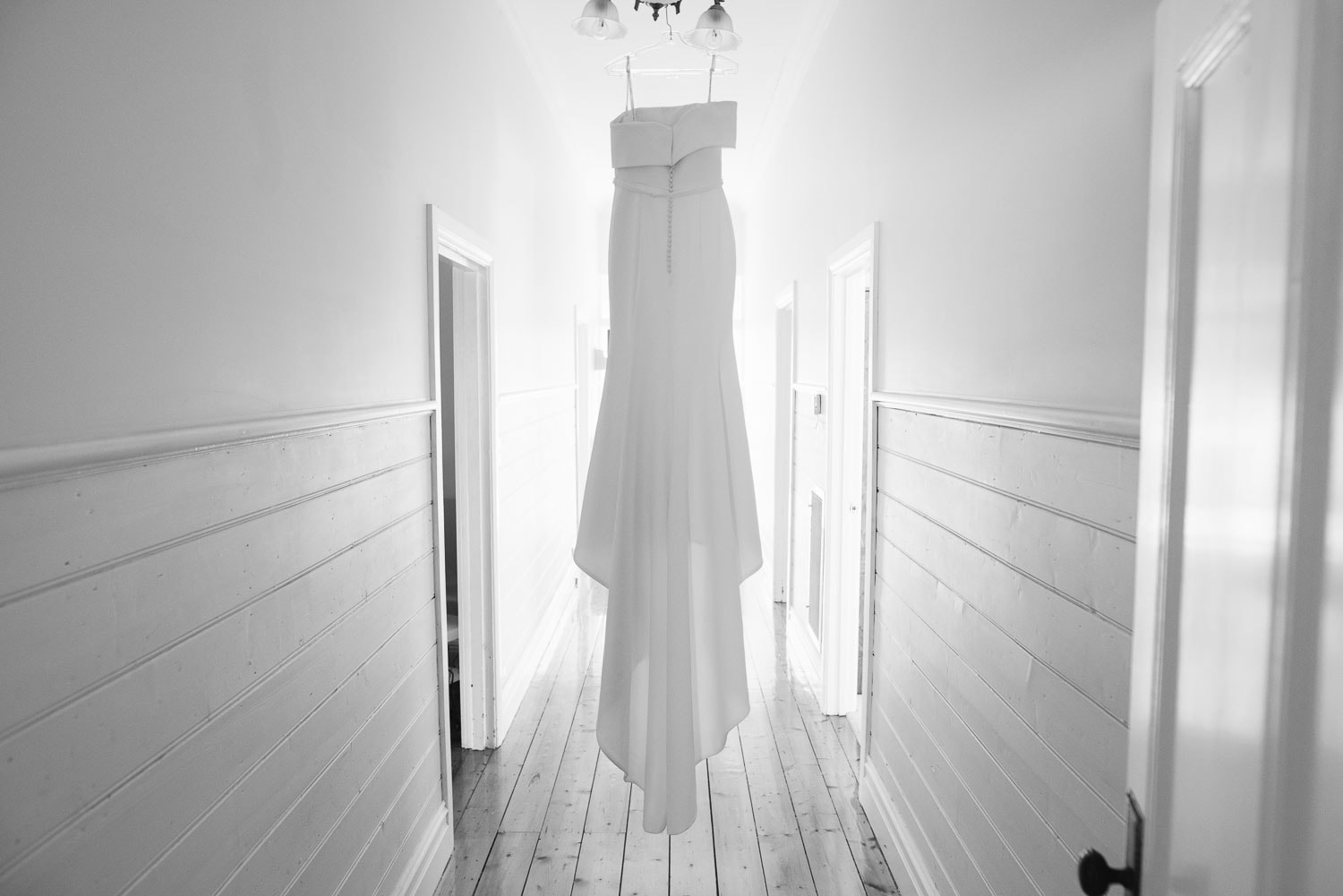 Wedding dress hung in Hamilton hallway