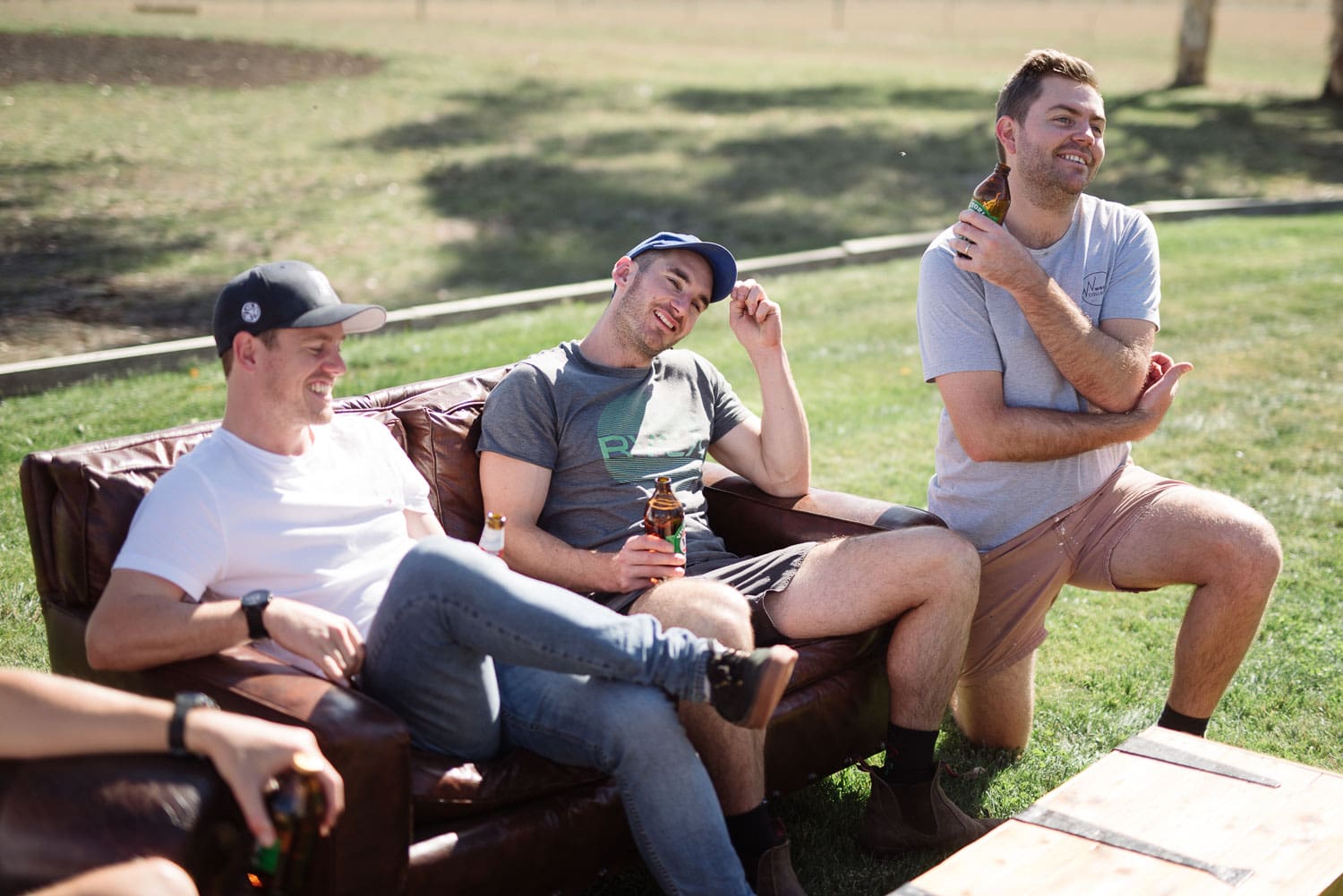 Groomsmen relaxing before a hamilton backyard wedding