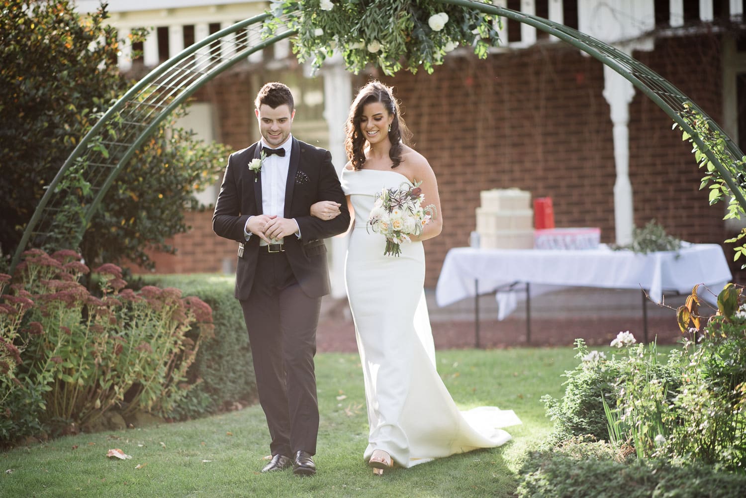 Bride walking down the aisle in her back garden