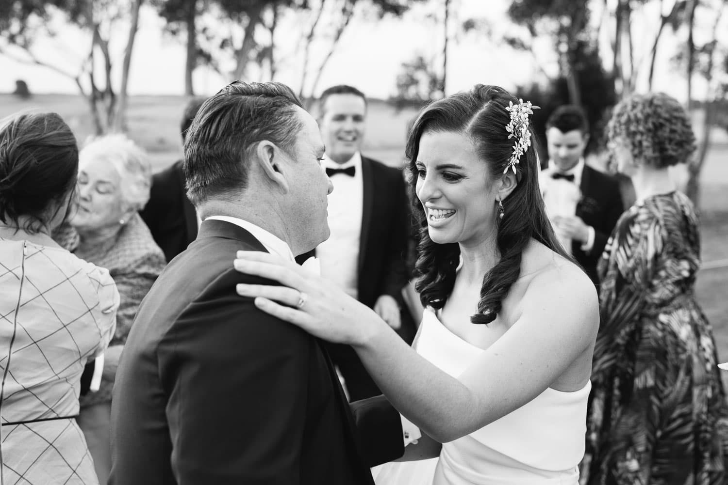 Bride and her father in a backyard