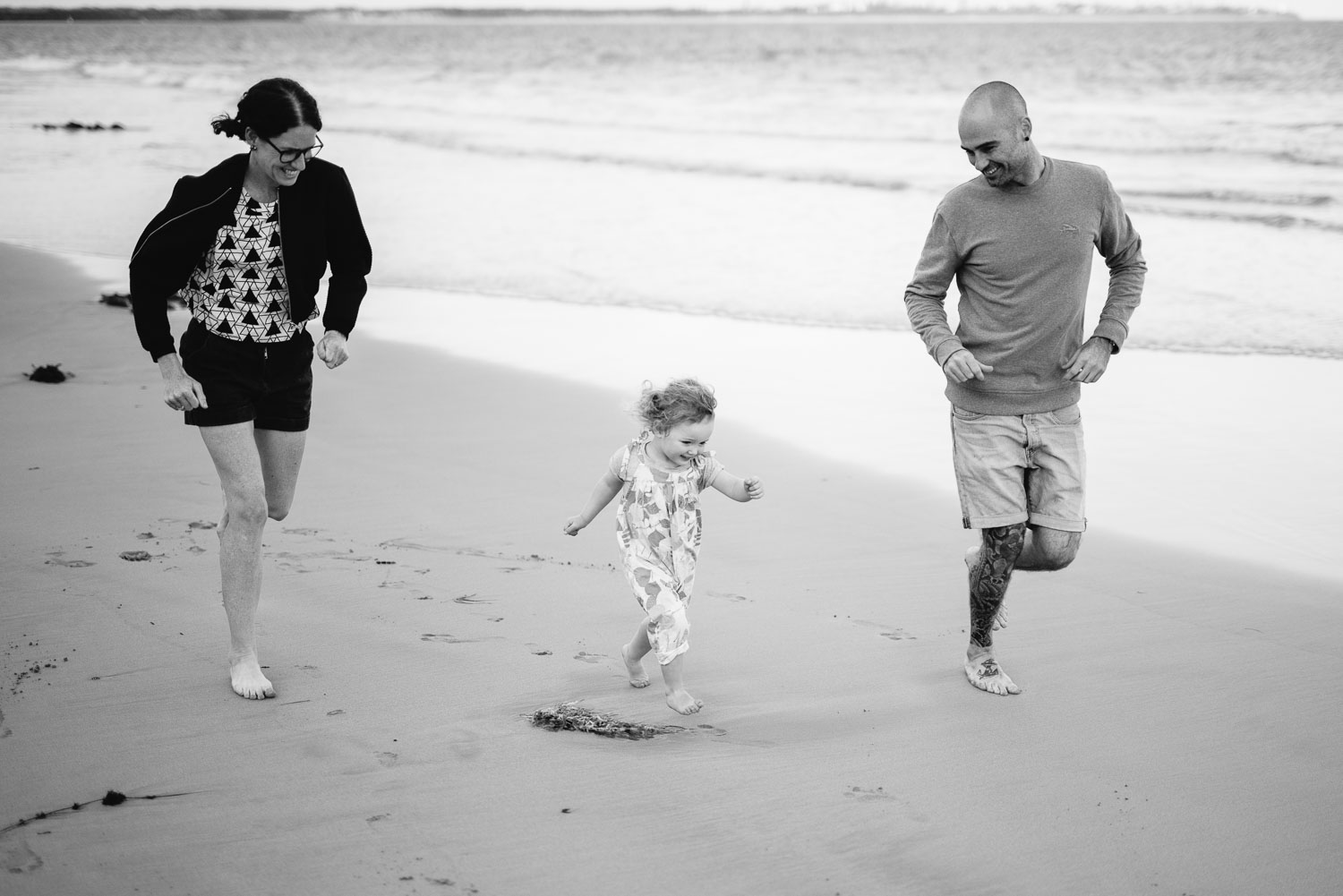 Family running on the beach at Point Lonsdale