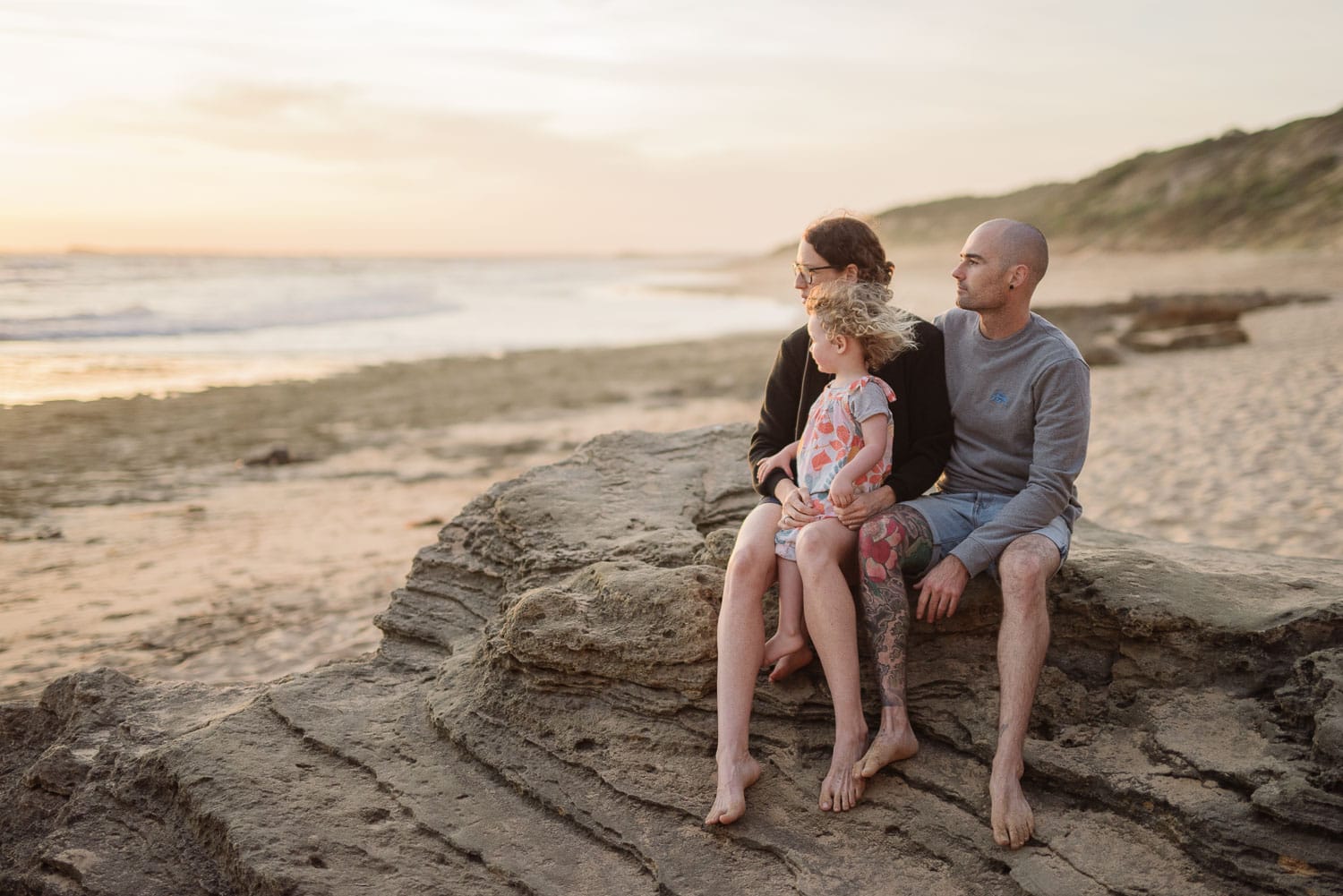 Family on the beach watching the sunset