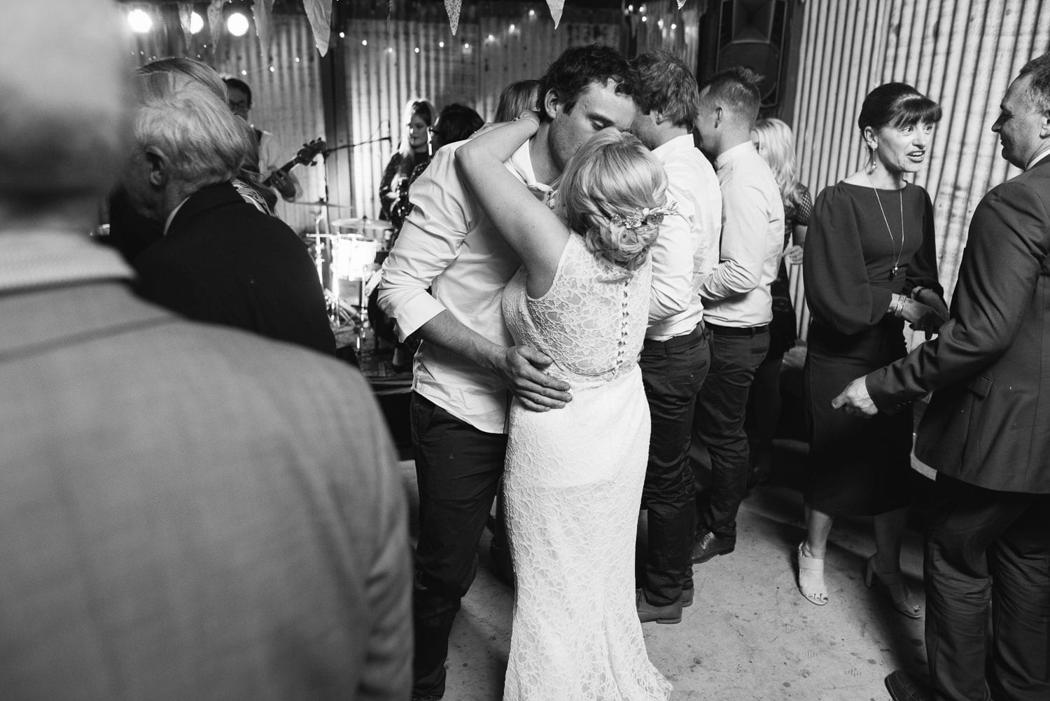 Bride and groom kiss on the dancefloor