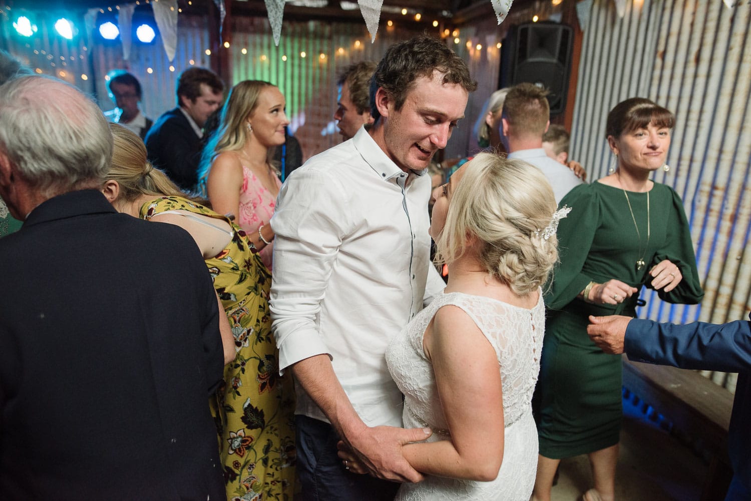 Happy groom dancing with his bride at their wedding