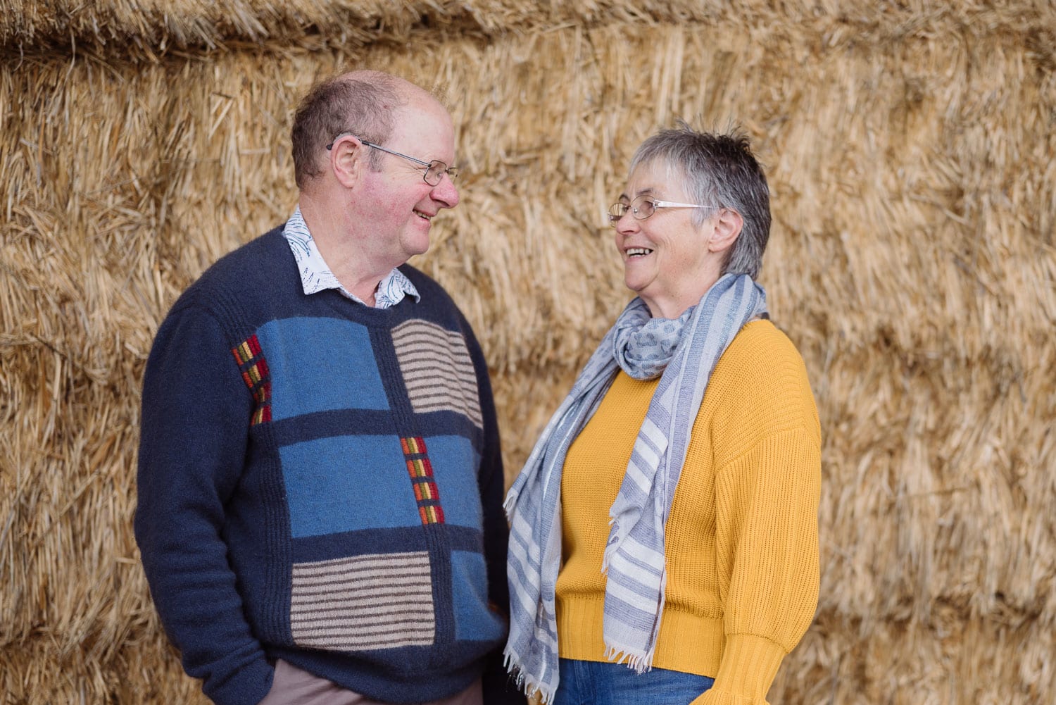 Portrait of an older couple in a hayshed