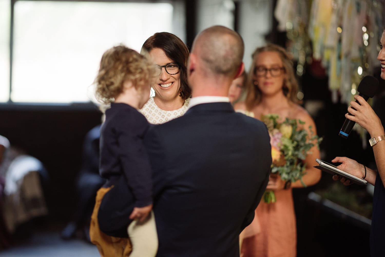 Bride looks at groom and her daughter