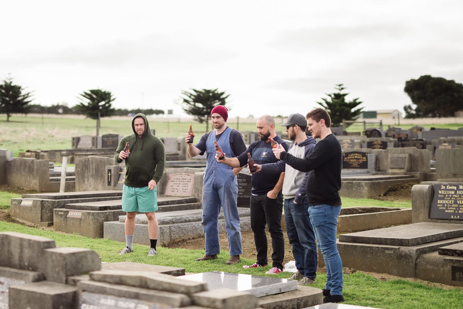 Groomsmen visit a relative's grave