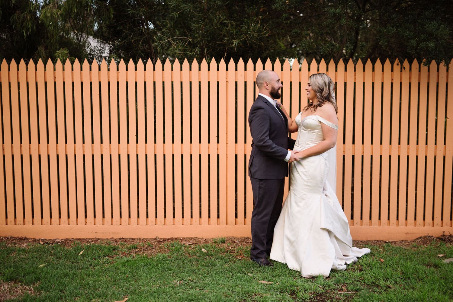 Wedding portrait with an orange fence