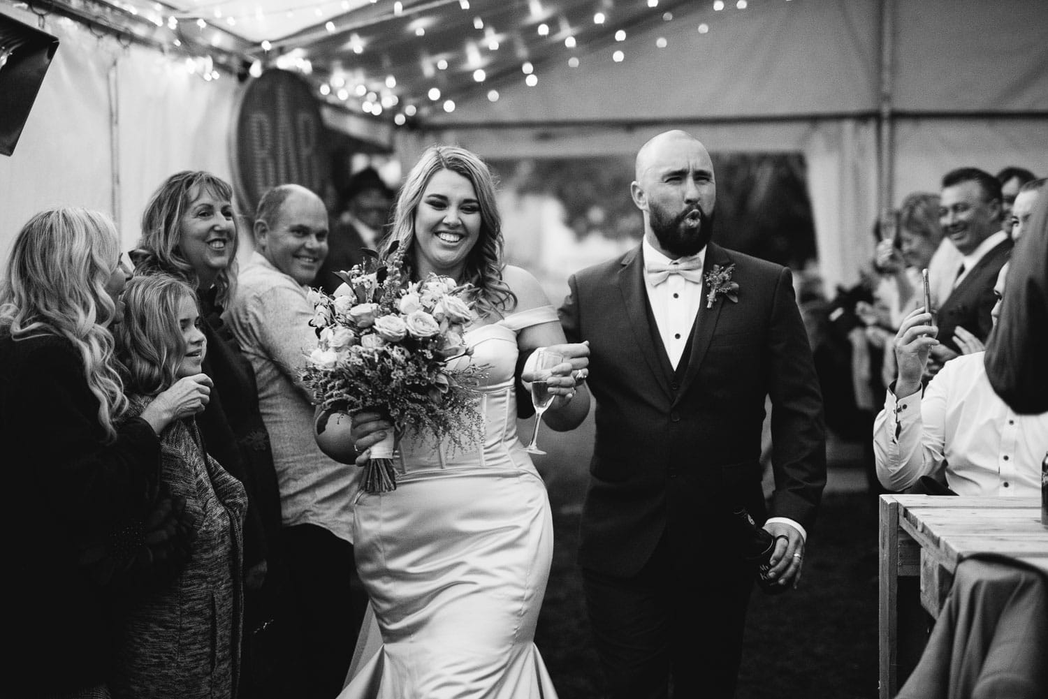 Bride and groom enter their wedding reception