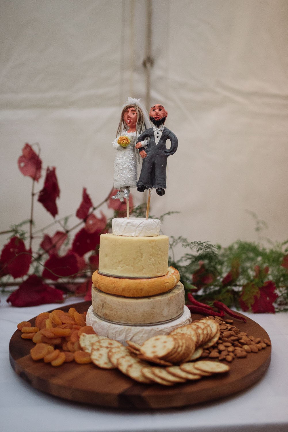 Cheese wheel cake with custom toppers