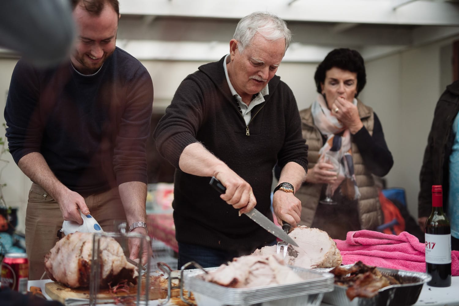 Carving meat at family birthday party