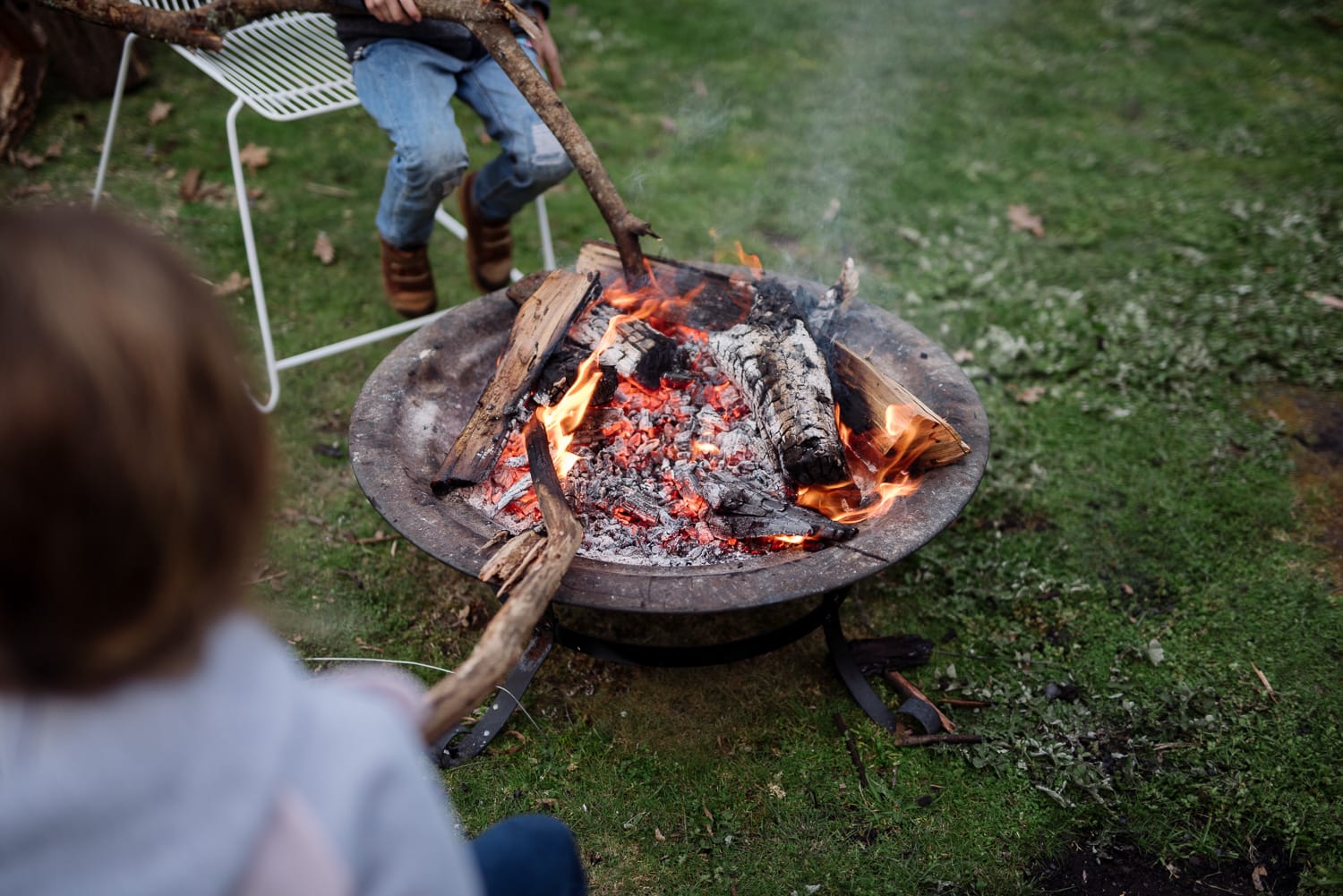 children playing around an open fire