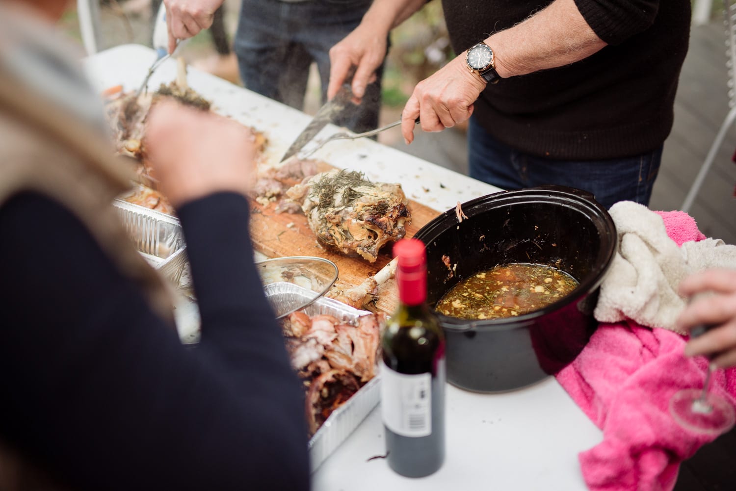 carving lamb at family gathering