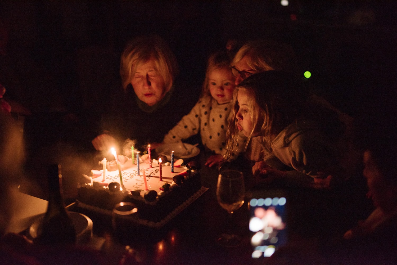 Child blows out birthday candles