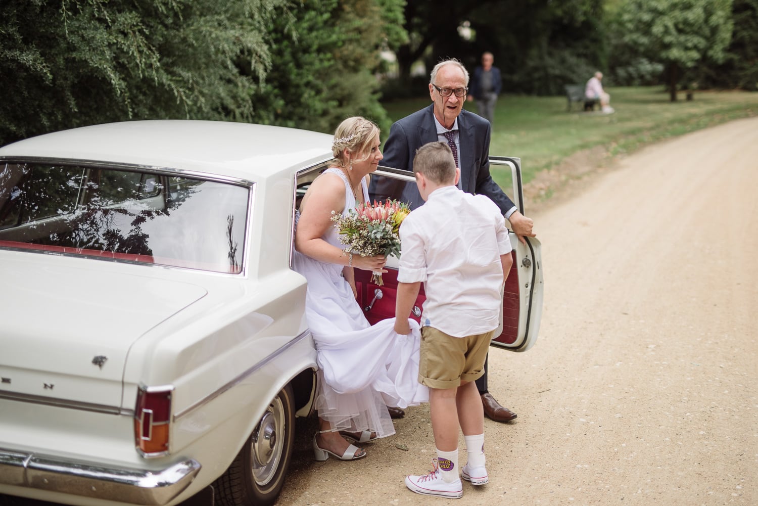 bride gets out of wedding car