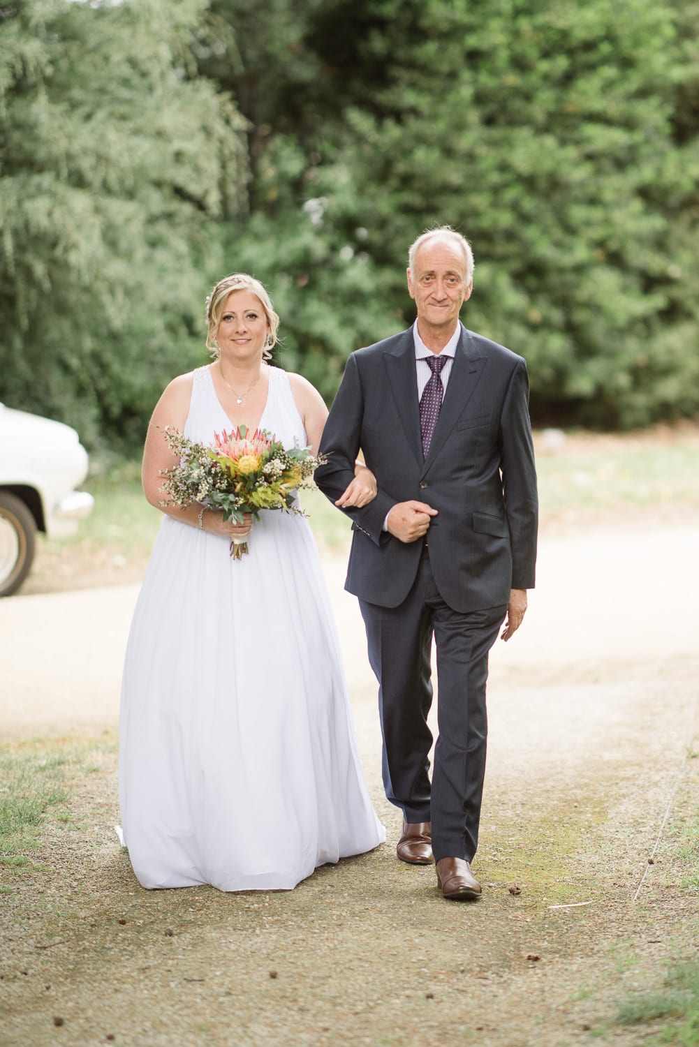 bride walking down the aisle in colac botanic gardens