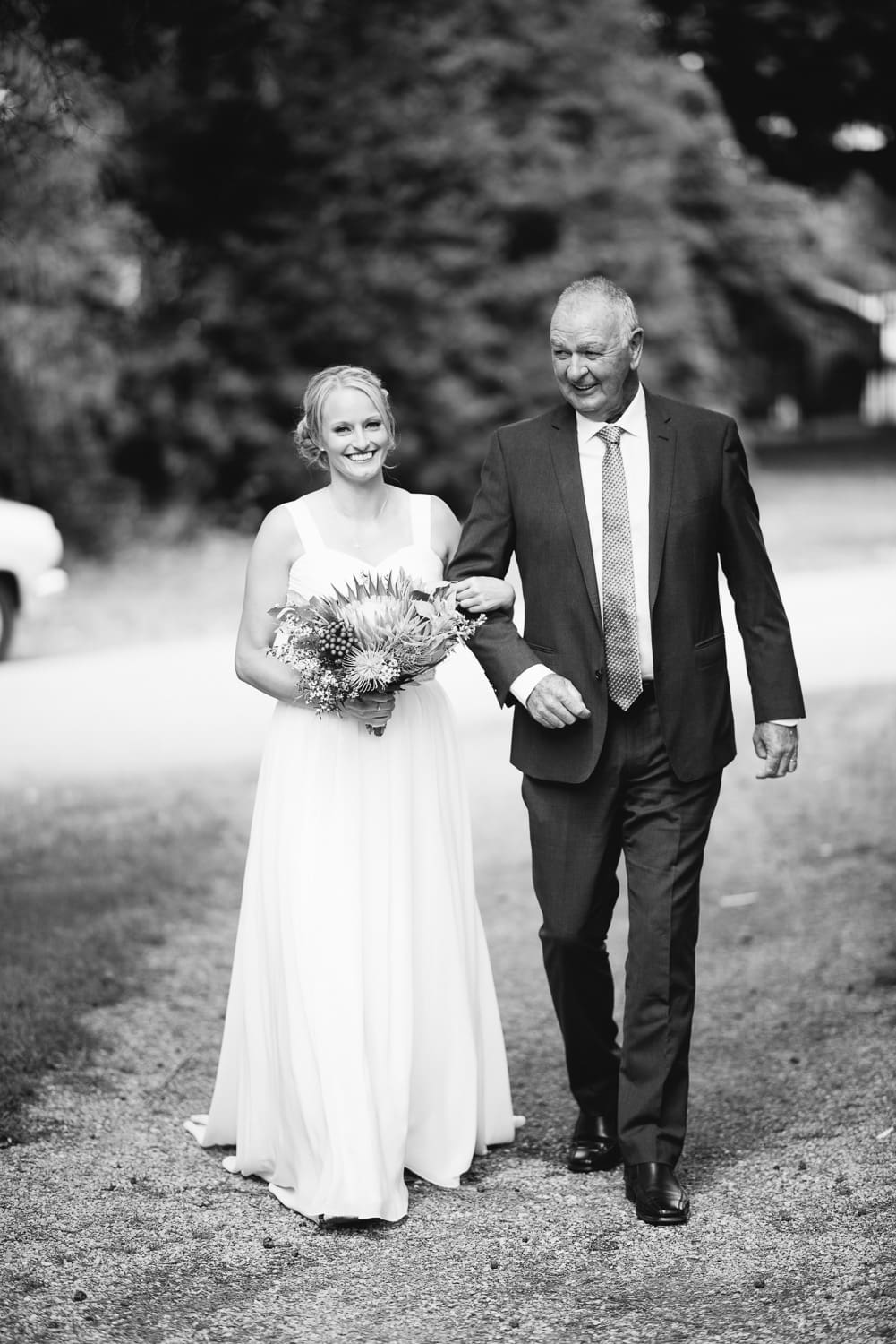 Bride walks down the aisle in colac botanic gardens