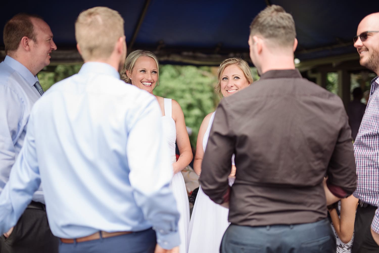 Brides having fun at their reception at the cafe on the lake