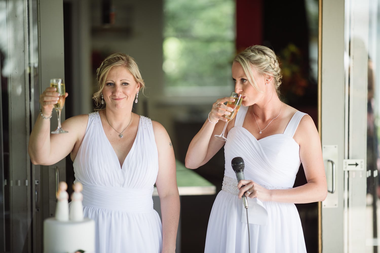 Brides toasting guests at their same sex wedding