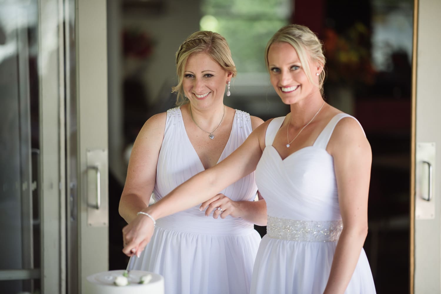 Brides cutting wedding cake