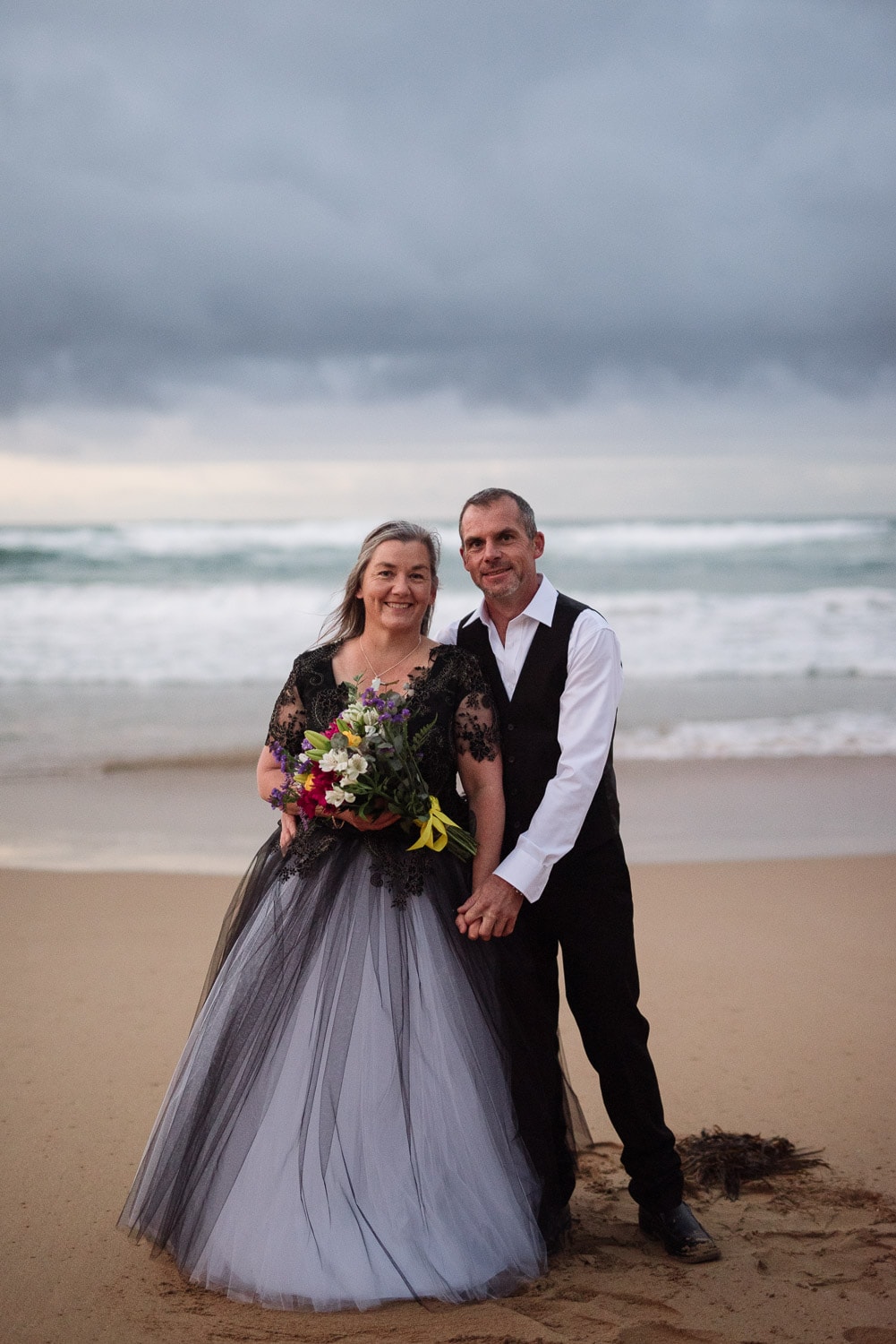 Bride and Groom smiling on the beach