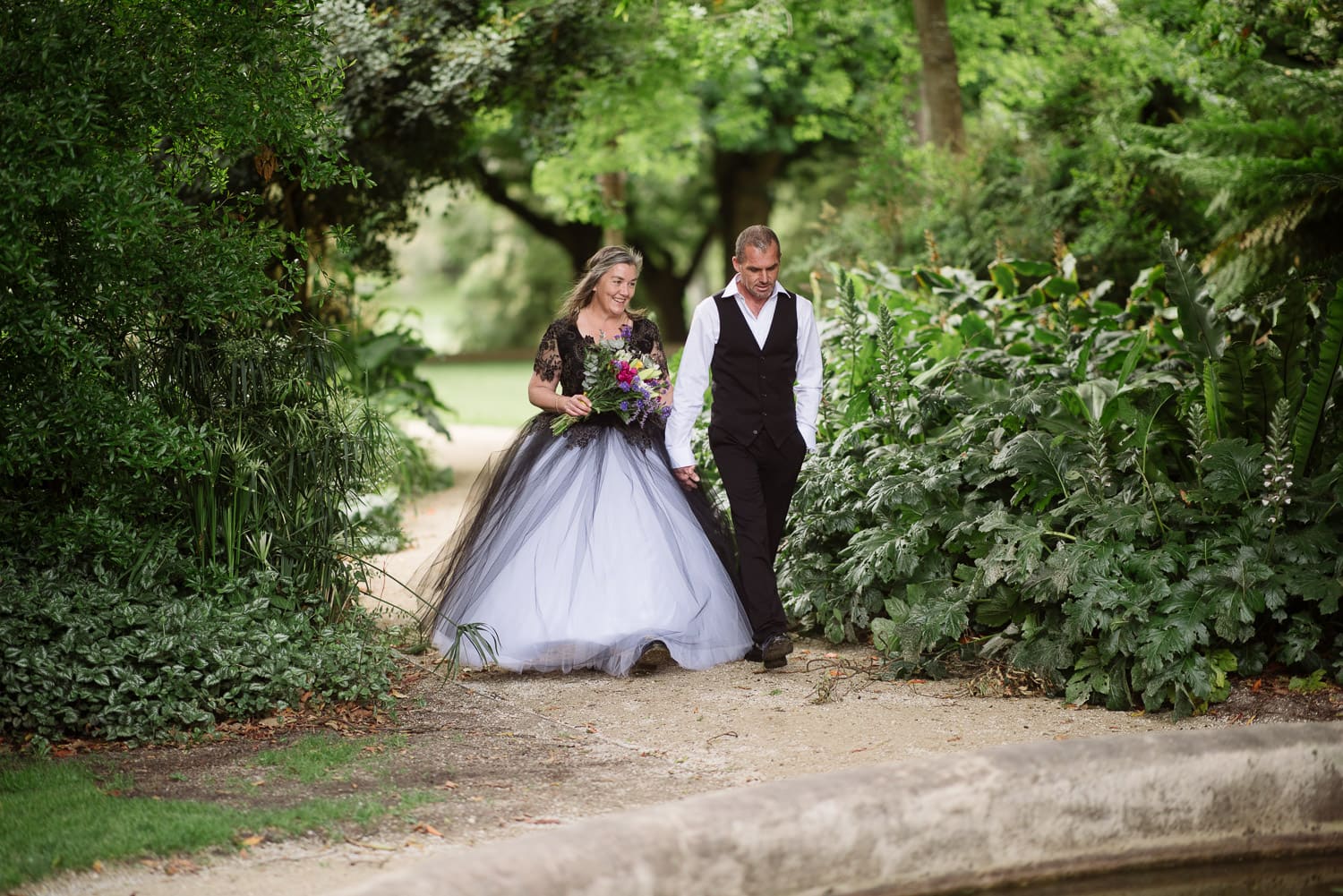 Bec and Ted enetering their wedding in Colac Botanic Gardens