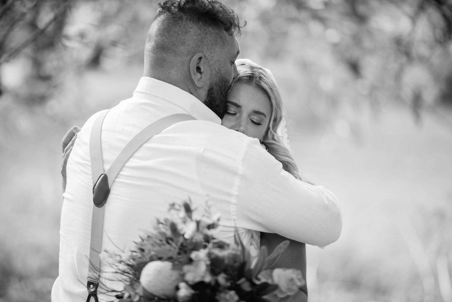 Big hug between bride and father