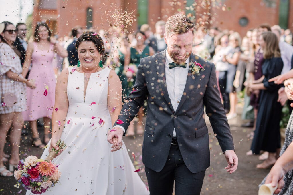 Bride and Groom covered in confetti after Koroit wedding near Warrnambool