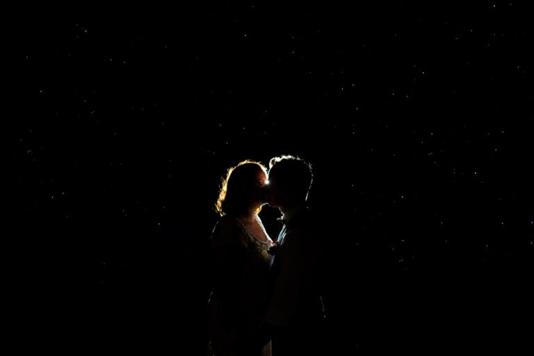 Wedding couple kissing under the stars