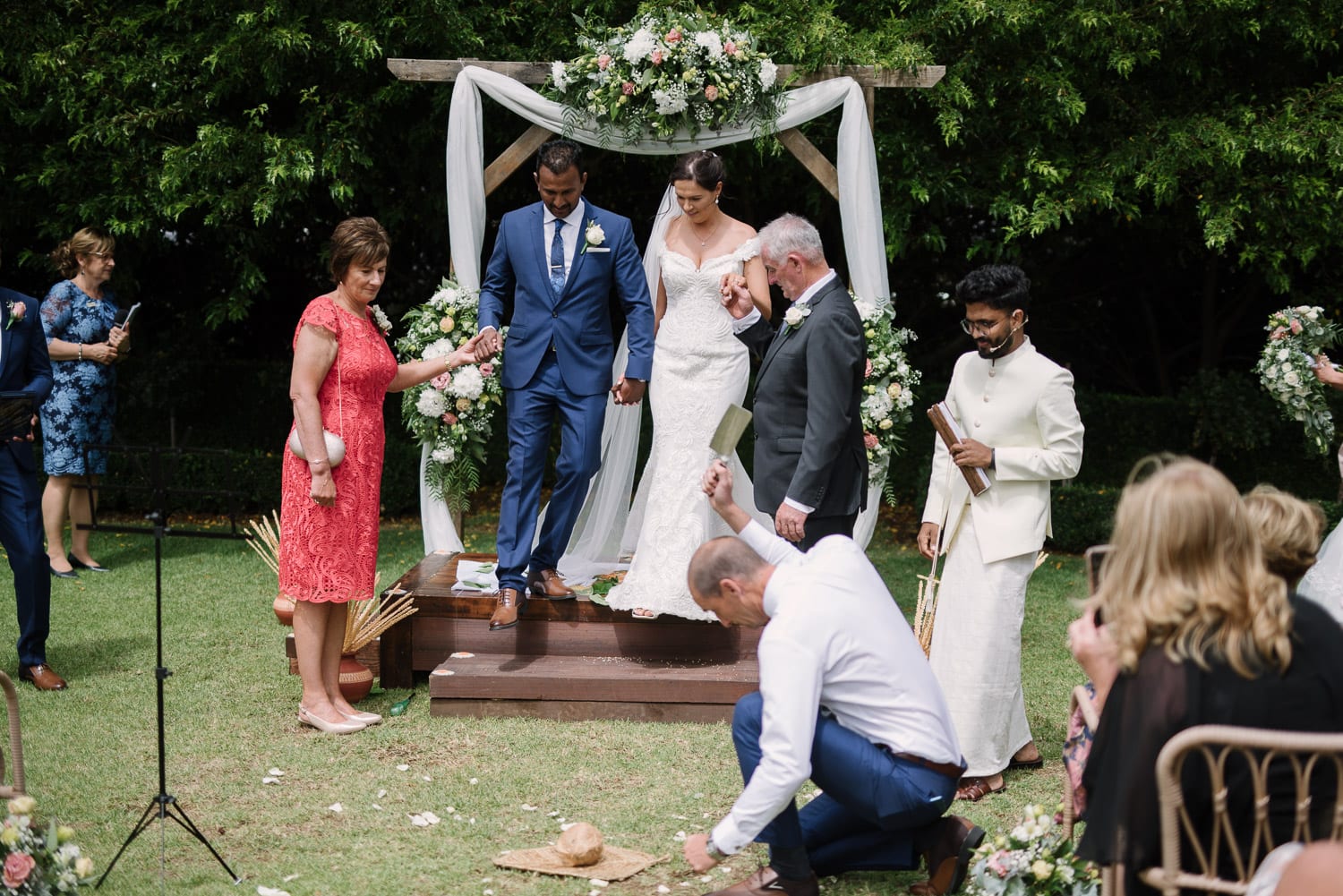 Sri Lankan traditional wedding coconut being smashed.