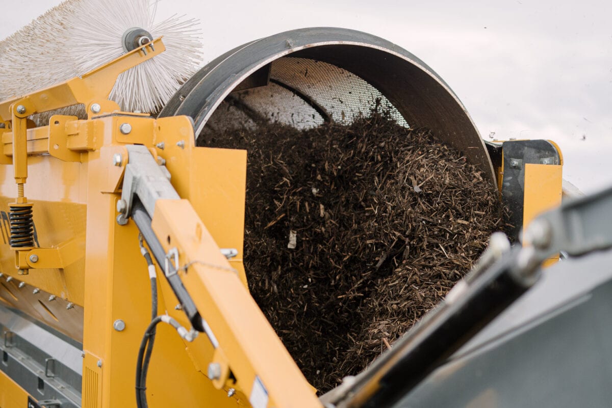 Mulch is passed through a rotating screen at the AORA conference demo day 2023