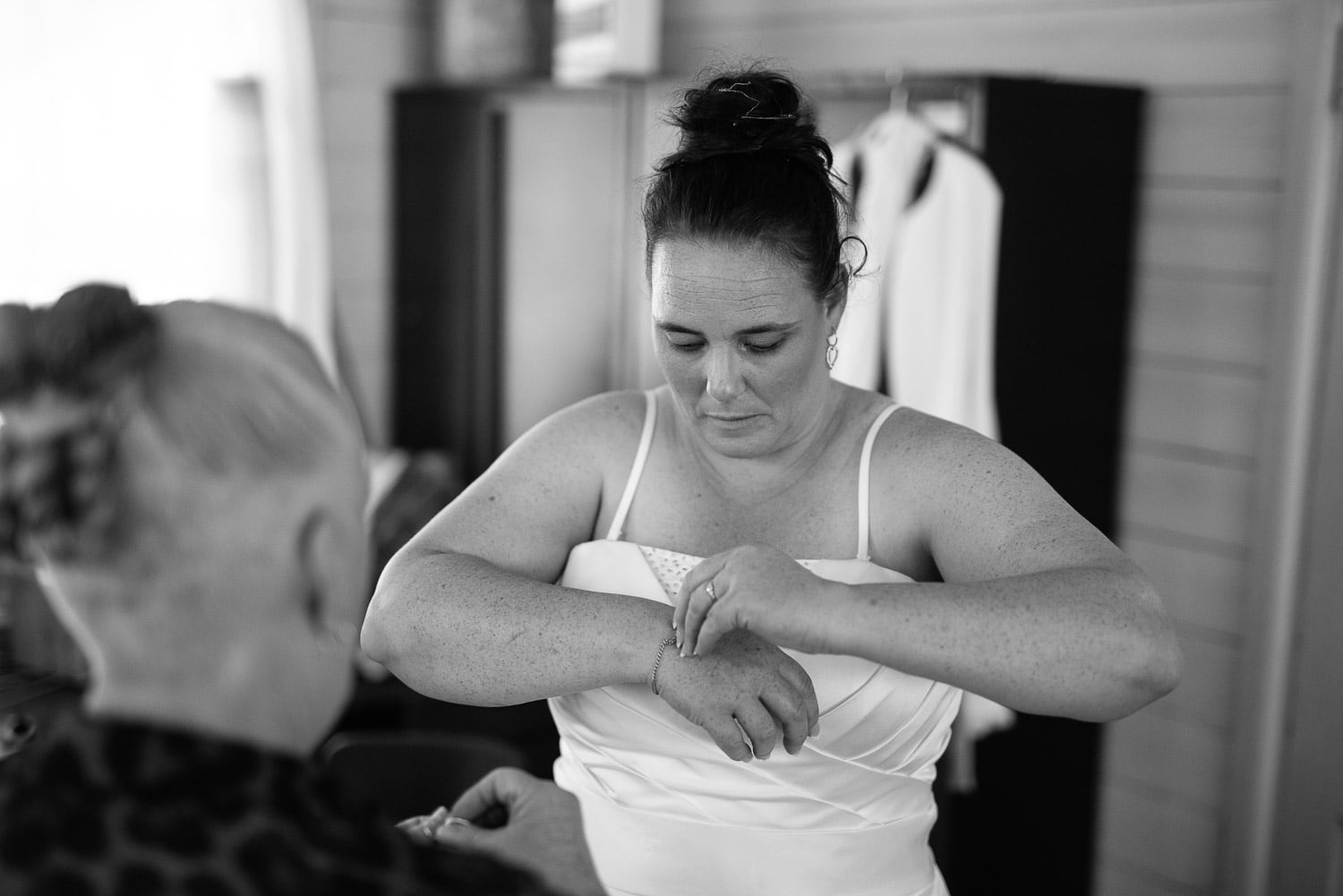 Bride putting on bracelet at Colac Scout Camp 