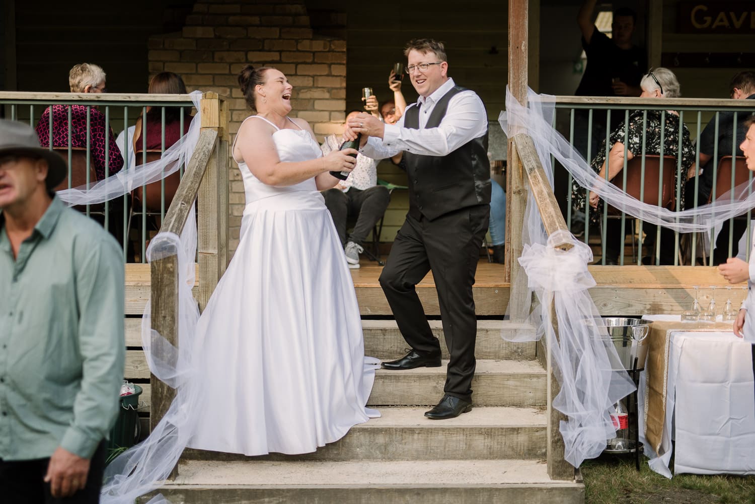 Popping champagne at a Colac wedding