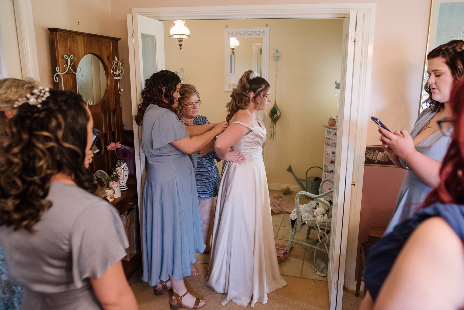 Bride putting dress on