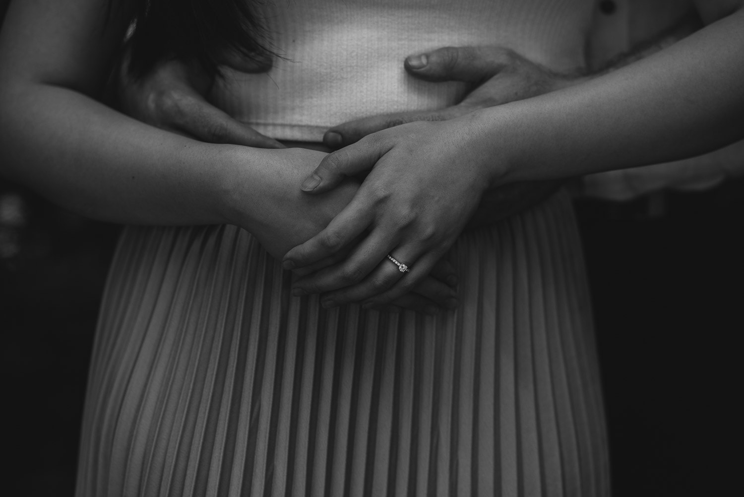 Enagaged couple's hands in black and white