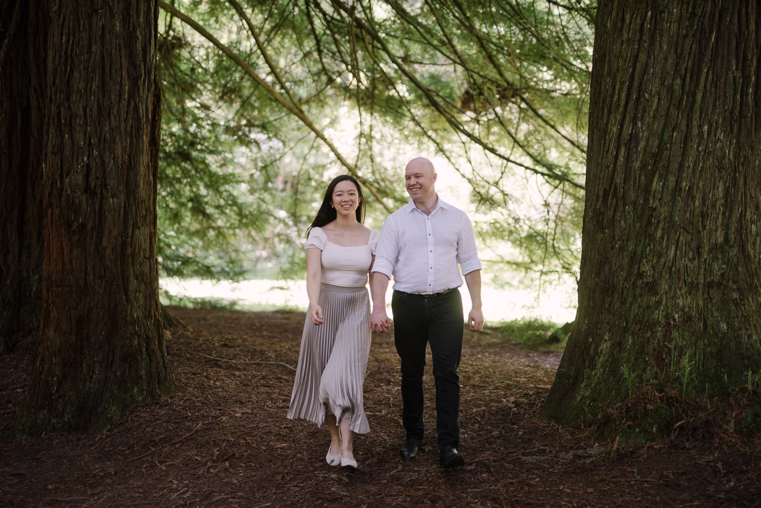 Happy couple among the redwood trees in the Otways