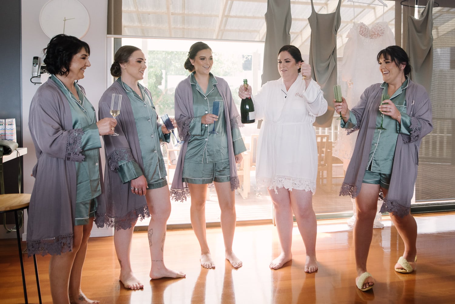 Bridesmaids drink champagne