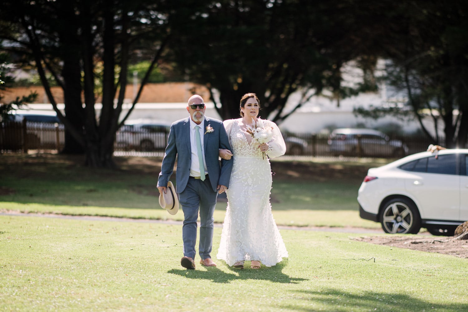Bride walks down aisle with father in Warrnambool Botanic Gardens